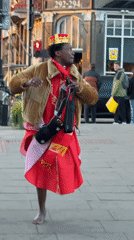 Crowned figure dances barefoot on London streets