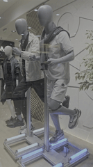 Shop window displays three running mannequins on metal structure