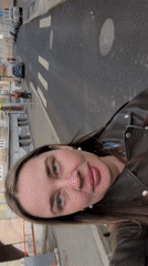 Woman in lettered shirt resting on bed in Moscow
