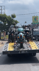 Tow truck transports three motorcycles in Sukawati, Indonesia