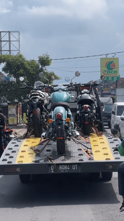 Tow truck transports three motorcycles in Sukawati, Indonesia