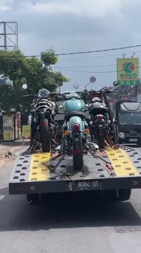 Tow truck transports three motorcycles in Sukawati, Indonesia