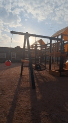 Child enjoys afternoon playground time in Russian villages