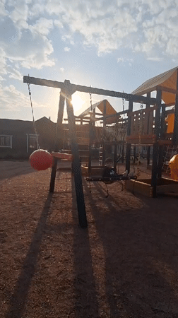 Child enjoys afternoon playground time in Russian villages