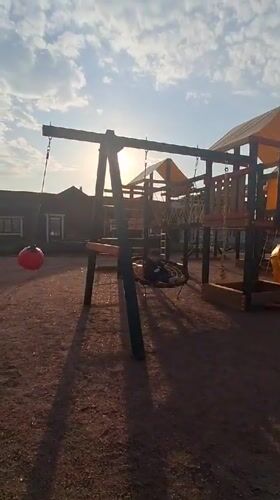 Child enjoys afternoon playground time in Russian villages