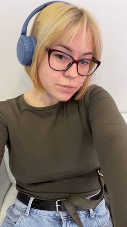 Woman in headphones sits on couch in Odesa