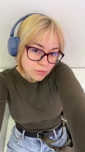 Woman in headphones sits on couch in Odesa