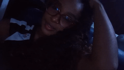Woman photographed making playful gesture in vehicle, Juan Griego
