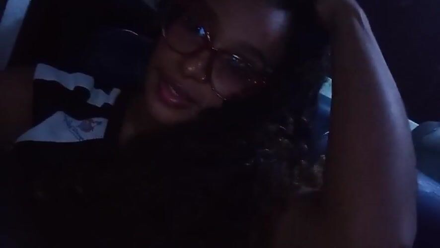 Woman photographed making playful gesture in vehicle, Juan Griego