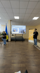 Indoor presentation in Myronivka with Ukrainian-language screen display