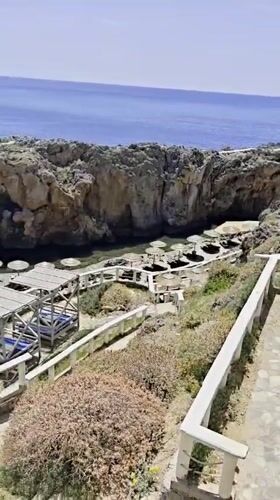 Tourist documents scenic coastal views in Plakias, Greece