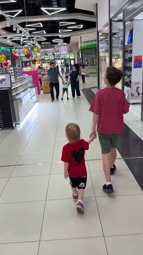 Children walk hand-in-hand through Tashkent shopping mall