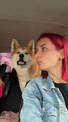 Pink-haired woman travels with dog, child in rainy Kamyennoye