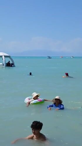 Crowded lakeside beach and open-air market in Kazakhstan