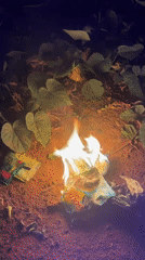 Small trash fire burns food packaging in rural Nigeria
