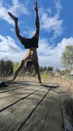 Man exercises with bulldog companion on Russian pier