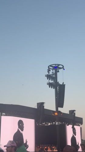 Daytime outdoor concert features vintage performance footage in La Quinta
