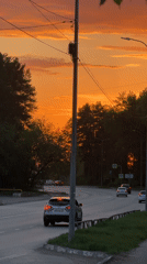 Evening traffic flows through tree-lined Chaikovsky streets at sunset