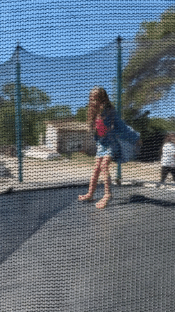 Girl plays on backyard trampoline in Montenegro village