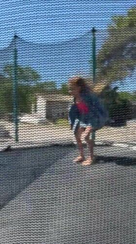 Girl plays on backyard trampoline in Montenegro village