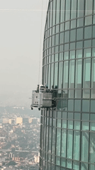 Window cleaners work on Mexico City skyscraper platform
