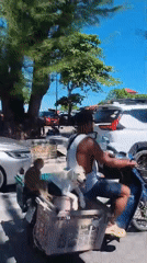 Scooter, dog, and monkey cruise through Nathon, Thailand