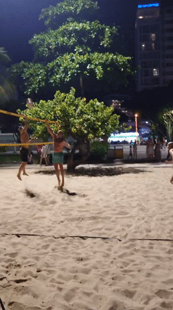 Nighttime beach bar scene with volleyball and coastal vibes