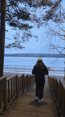 Woman exercises at sunrise along Chaikovsky waterfront embankment