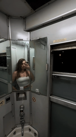 Woman takes selfies in Montenegro train restroom