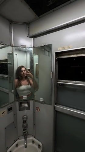Woman takes selfies in Montenegro train restroom