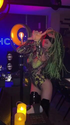 Green-haired dancer performs at Novosibirsk nightclub celebration with sparklers