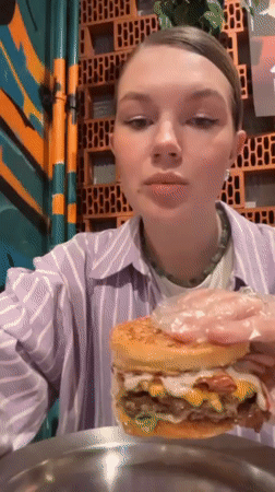 Woman dines at Belgrade restaurant during rainy evening