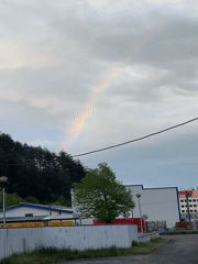 Rainbow appears over Zlatograd, Bulgaria during cloudy afternoon