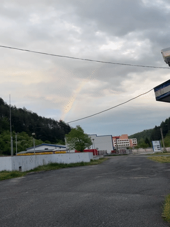 Rainbow appears over Zlatograd, Bulgaria during cloudy afternoon