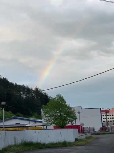 Rainbow appears over Zlatograd, Bulgaria during cloudy afternoon