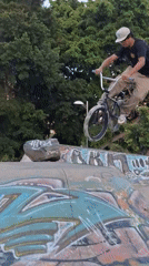 BMX rider performs tricks on graffitied ramp in Tenerife park