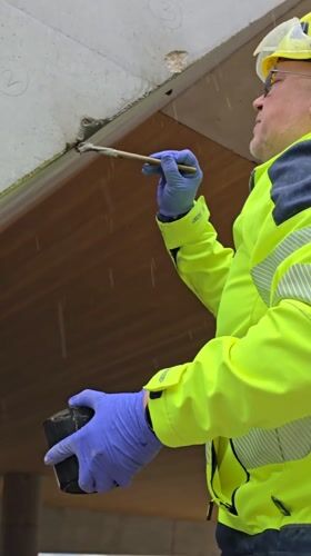 Construction workers repair concrete structures in Ramat HaSharon