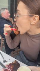 Woman enjoys chocolate pastry at outdoor café in Batumi
