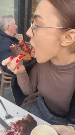 Woman enjoys chocolate pastry at outdoor café in Batumi