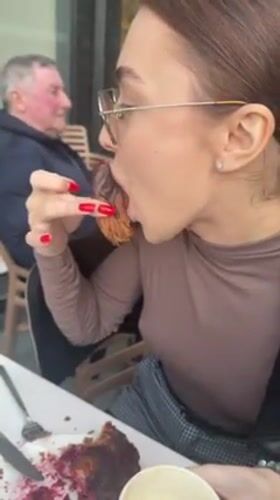 Woman enjoys chocolate pastry at outdoor café in Batumi