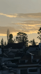Golden Buddha statue observed at sunrise in Đà Lạt