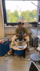 Young potter works at wheel in Moscow studio