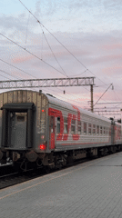 Passenger train documented at Izhevsk station during evening hours
