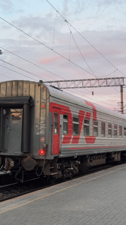 Passenger train documented at Izhevsk station during evening hours