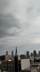 Rooftop observers document overcast evening skyline across NYC