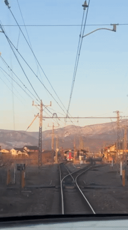 Train passenger films approach to Obuse station, red train visible
