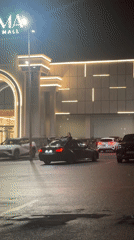Person stands through sunroof at Yerevan mall parking lot