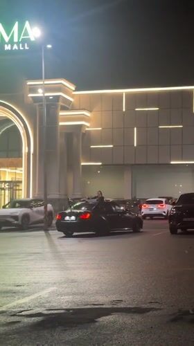 Person stands through sunroof at Yerevan mall parking lot