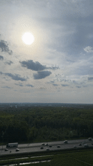 Aerial view captures highway traffic through wooded area