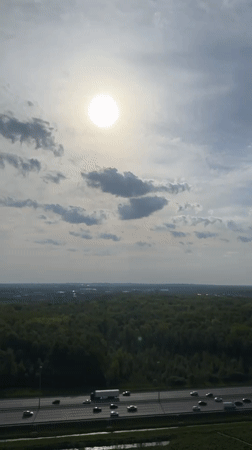 Aerial view captures highway traffic through wooded area